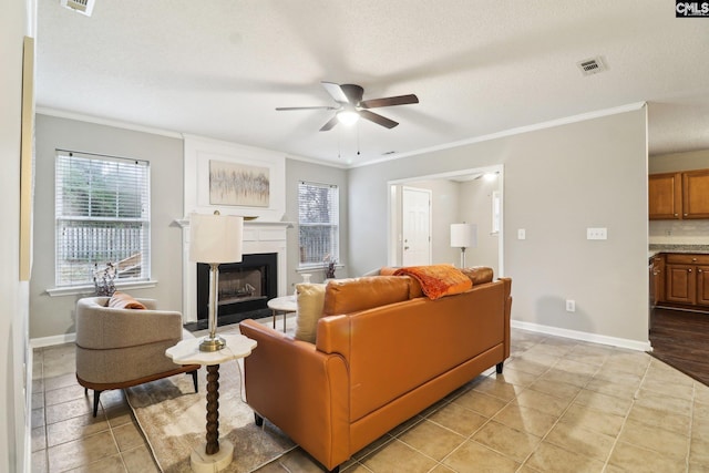 208 Bailey Island Cir, Lexington, SC 29072 - living area featuring ornamental molding, a fireplace, baseboards, visible vents, and a ceiling fan