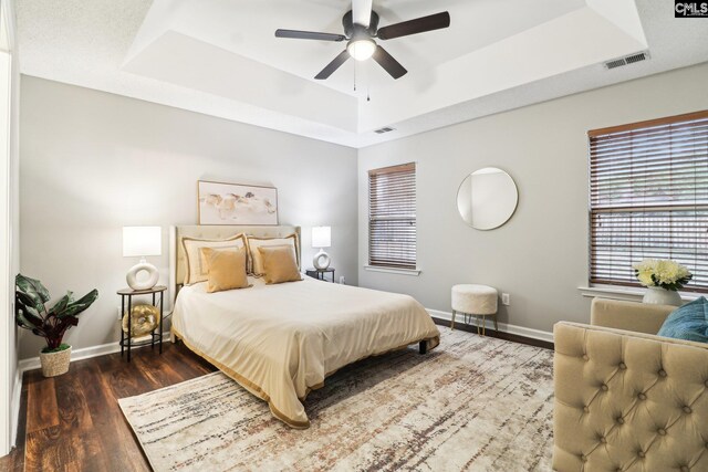 208 Bailey Island Cir, Lexington, SC 29072 - bedroom featuring visible vents, baseboards, wood finished floors, and a tray ceiling