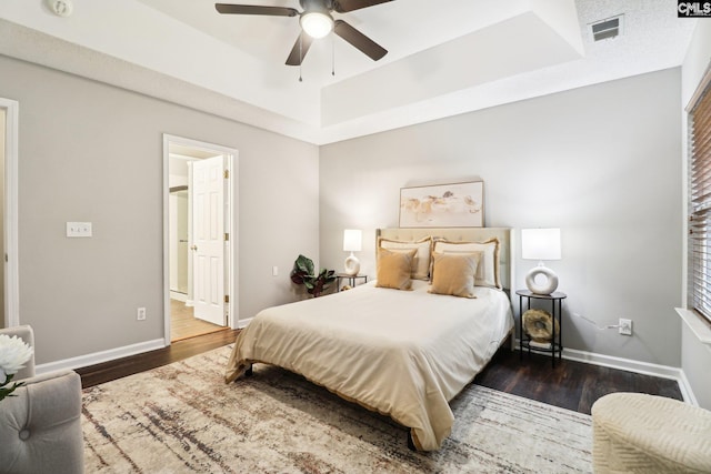 208 Bailey Island Cir, Lexington, SC 29072 - bedroom featuring visible vents, baseboards, wood finished floors, and a tray ceiling