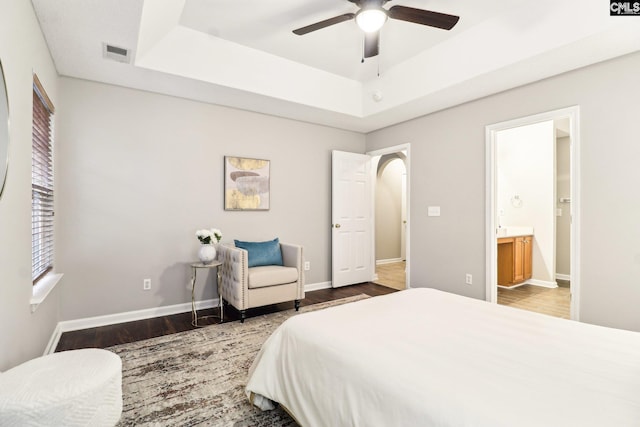 208 Bailey Island Cir, Lexington, SC 29072 - bedroom featuring visible vents, wood finished floors, arched walkways, and a tray ceiling