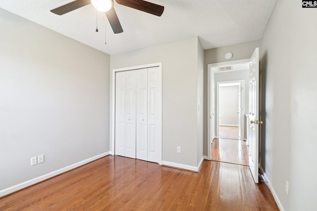208 Bailey Island Cir, Lexington, SC 29072 - unfurnished bedroom featuring wood finished floors, baseboards, a ceiling fan, and a closet