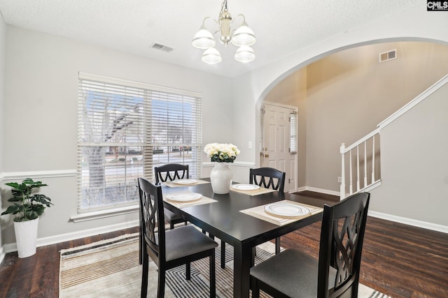 208 Bailey Island Cir, Lexington, SC 29072 - dining space with stairway, a notable chandelier, visible vents, arched walkways, and wood finished floors