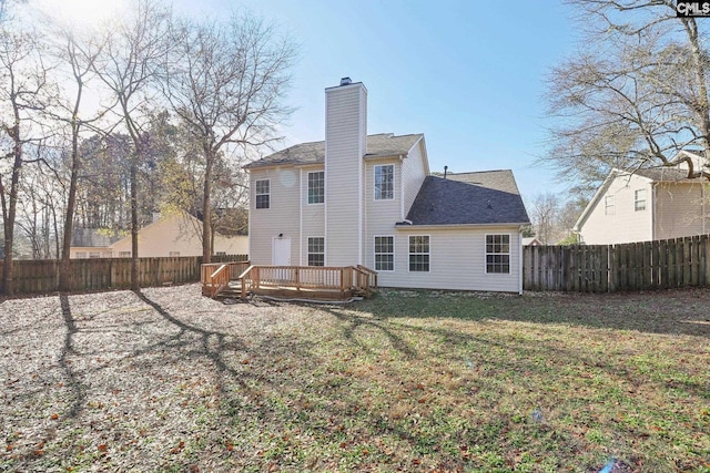 208 Bailey Island Cir, Lexington, SC 29072 - back of house with a chimney, a deck, a shingled roof, a yard, and a fenced backyard