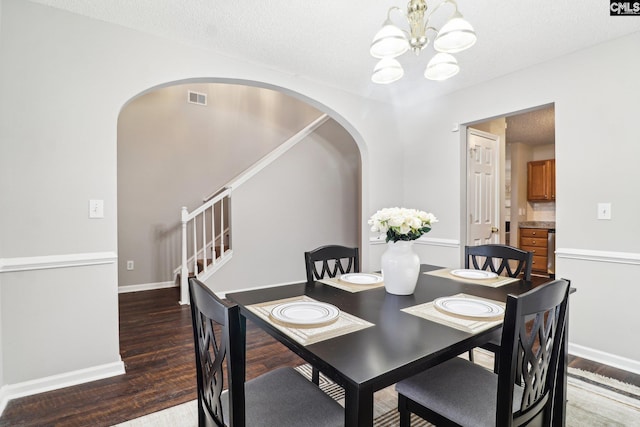 208 Bailey Island Cir, Lexington, SC 29072 - dining area featuring arched walkways, an inviting chandelier, wood finished floors, stairway, and visible vents
