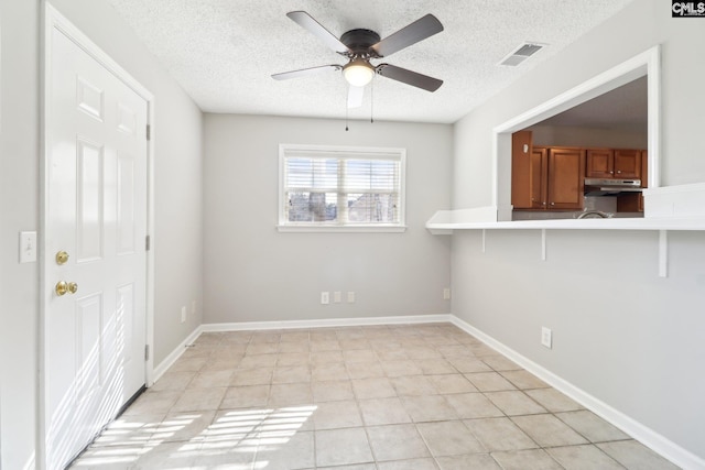 208 Bailey Island Cir, Lexington, SC 29072 - spare room with visible vents, ceiling fan, a textured ceiling, and light tile patterned flooring