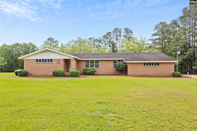 ranch-style home with brick siding, a front yard, and crawl space