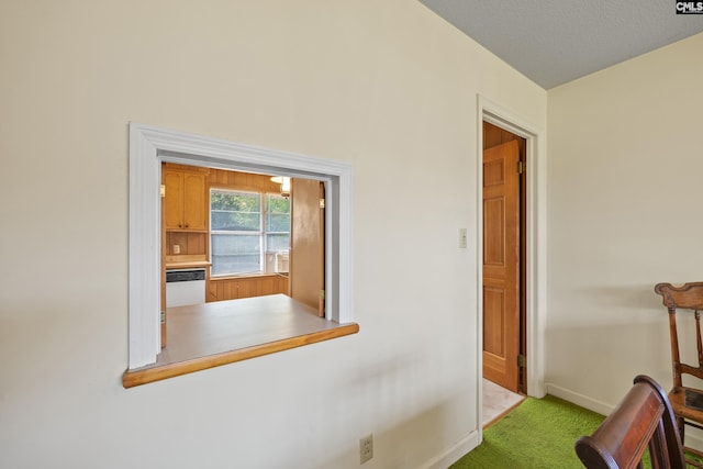 corridor featuring carpet floors and baseboards