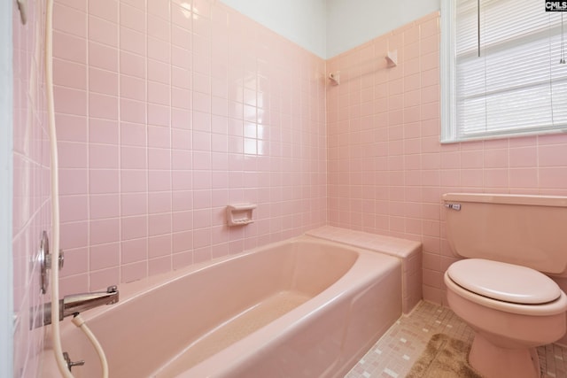 full bathroom featuring toilet, tile walls, and tile patterned floors