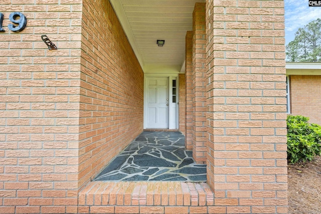 view of exterior entry with brick siding