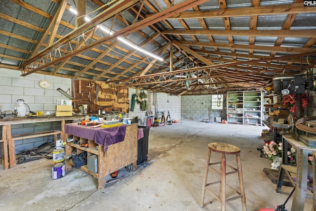 garage with a workshop area and concrete block wall