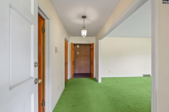 hallway with baseboards and carpet floors