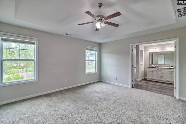 unfurnished bedroom with baseboards, visible vents, carpet floors, and lofted ceiling