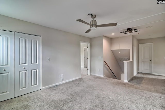 unfurnished living room featuring attic access, recessed lighting, ceiling fan, carpet, and baseboards