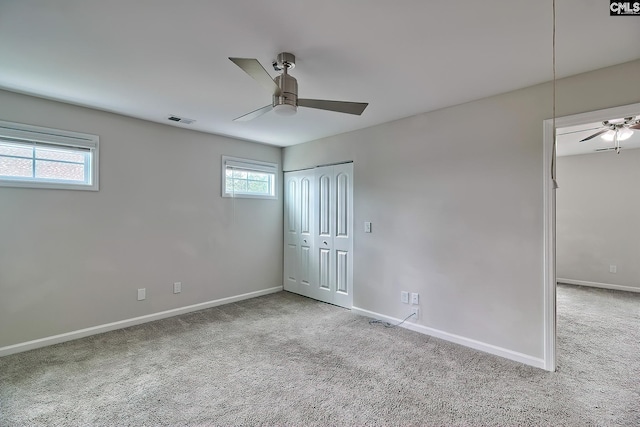 unfurnished bedroom with visible vents, baseboards, a ceiling fan, and carpet floors