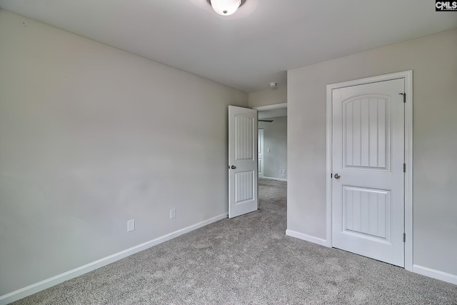 unfurnished bedroom featuring carpet floors and baseboards
