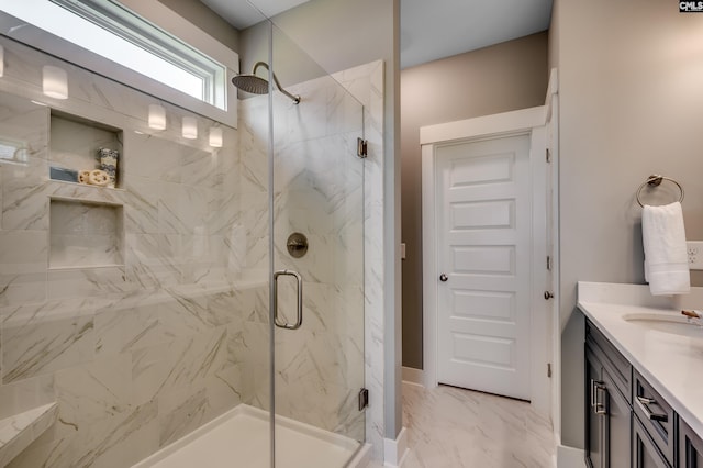bathroom with vanity, marble finish floor, and a marble finish shower