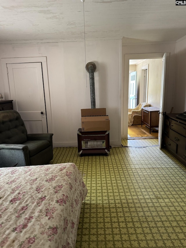 bedroom featuring baseboards and a wood stove