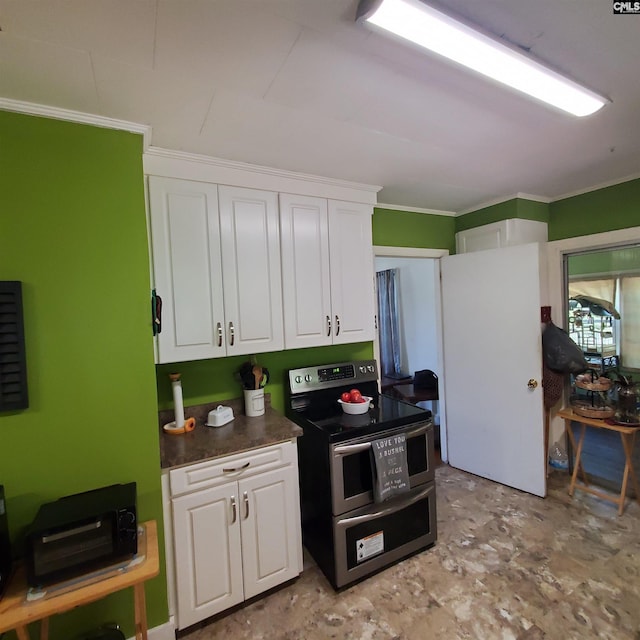 kitchen with crown molding, double oven range, dark countertops, and white cabinets