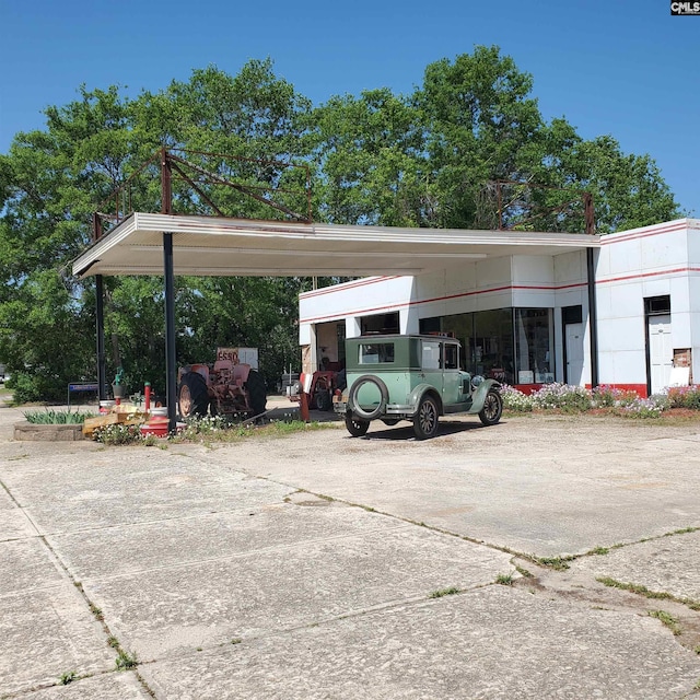 view of vehicle parking featuring concrete driveway and a carport