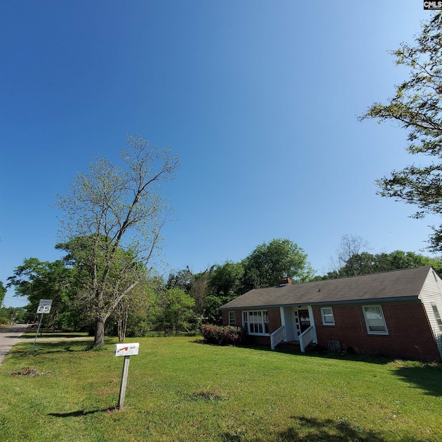 single story home featuring a front yard and brick siding