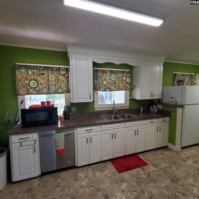 kitchen with stainless steel dishwasher, freestanding refrigerator, ornamental molding, a sink, and black microwave