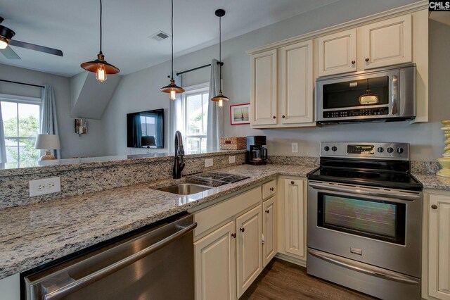 821 Harborside Ln, Columbia, SC 29229 - kitchen featuring visible vents, a sink, light stone counters, stainless steel appliances, and cream cabinetry