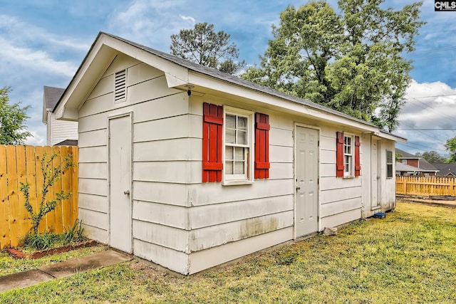 view of outbuilding with fence