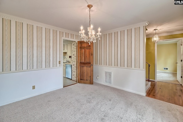 unfurnished dining area featuring a chandelier, visible vents, and wallpapered walls
