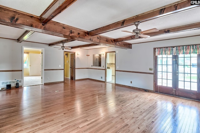 interior space featuring baseboards, beamed ceiling, a ceiling fan, and light wood-style flooring