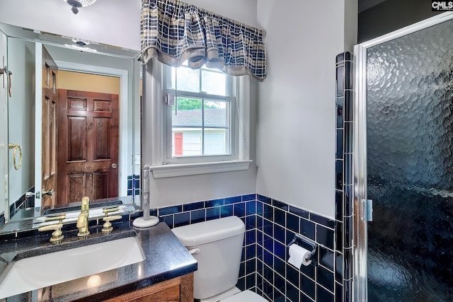 full bath with a shower stall, a wainscoted wall, toilet, tile walls, and vanity