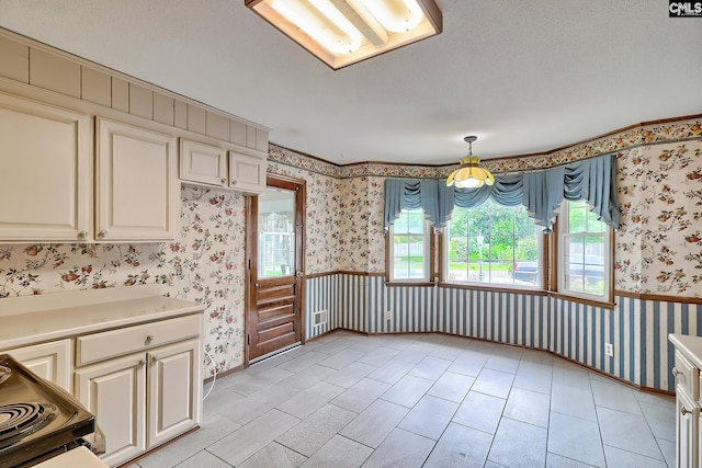 unfurnished dining area with a ceiling fan, wallpapered walls, and baseboards