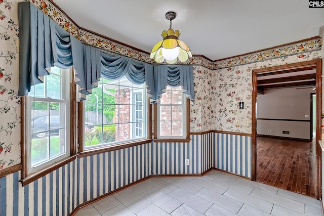 unfurnished dining area with visible vents, wallpapered walls, and plenty of natural light