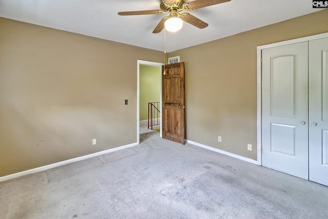 unfurnished bedroom featuring visible vents, a closet, carpet flooring, and baseboards