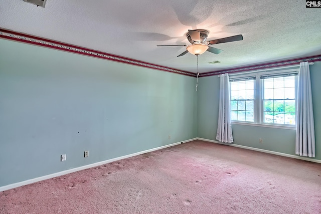 carpeted empty room featuring baseboards, ceiling fan, and a textured ceiling
