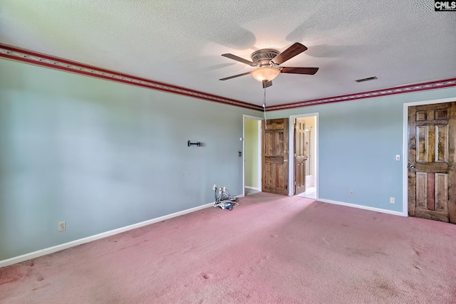 unfurnished room featuring carpet flooring, a ceiling fan, visible vents, and baseboards