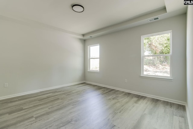 spare room with visible vents, a healthy amount of sunlight, and baseboards