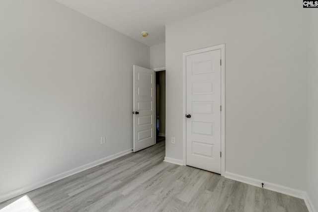unfurnished bedroom featuring baseboards and light wood-style flooring