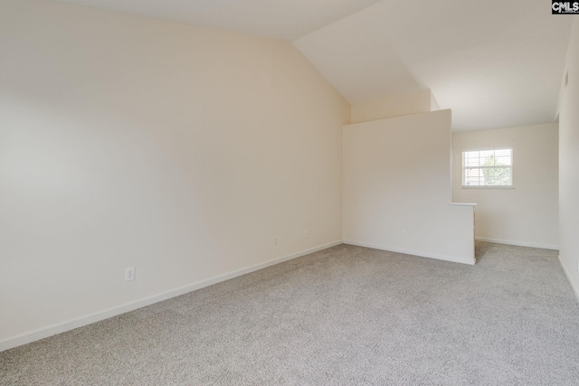 additional living space with baseboards, carpet floors, and lofted ceiling