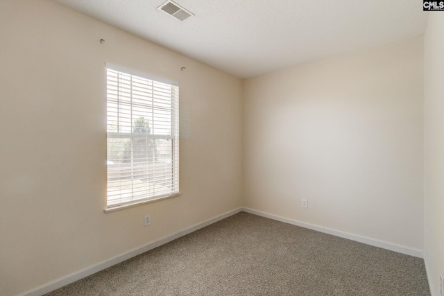 carpeted empty room with baseboards and visible vents