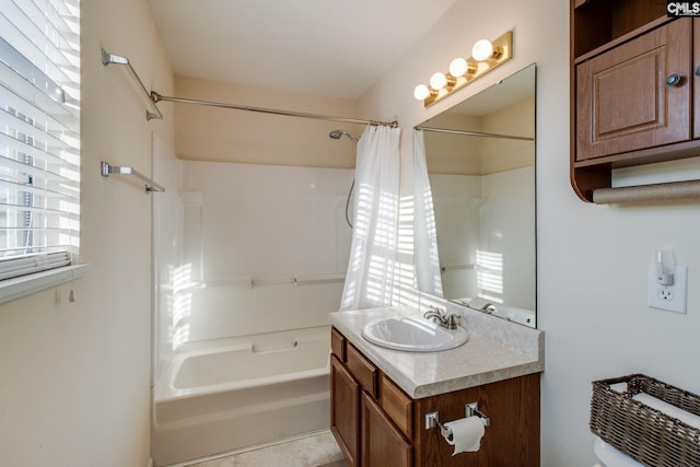 bathroom featuring toilet, vanity, and shower / tub combo with curtain