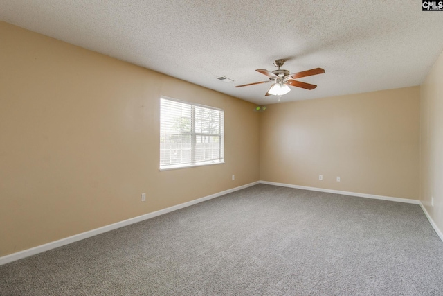 carpeted spare room featuring a textured ceiling, ceiling fan, visible vents, and baseboards