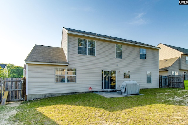rear view of property with a gate, a fenced backyard, a patio area, and a lawn