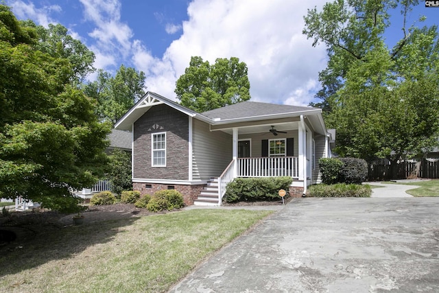 bungalow-style house featuring a porch, crawl space, a ceiling fan, a front lawn, and a shingled roof