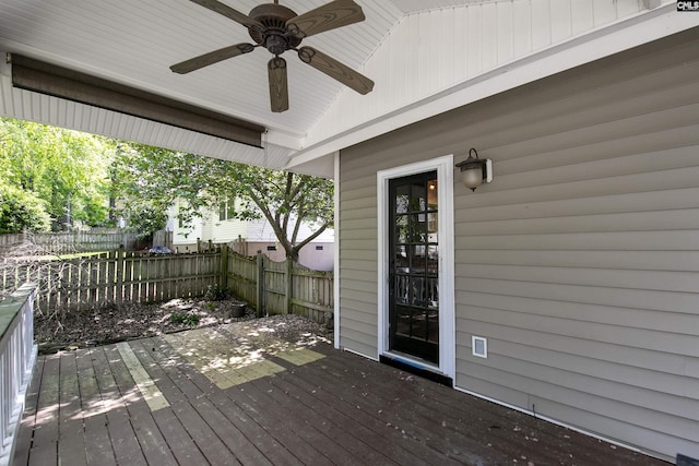 wooden terrace featuring ceiling fan and a fenced backyard