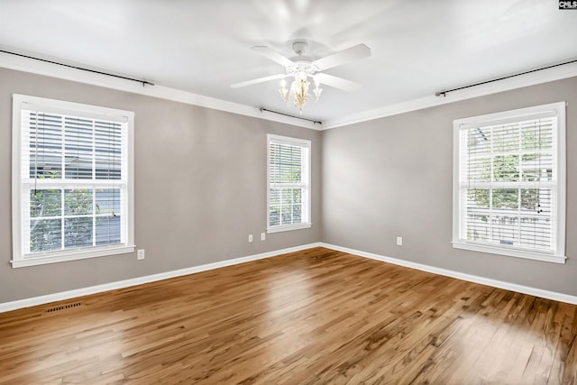 spare room featuring baseboards, visible vents, a healthy amount of sunlight, and light wood-style floors
