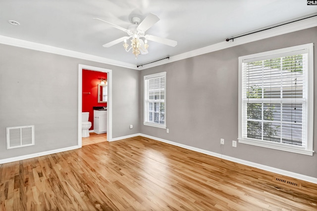 empty room featuring baseboards, a ceiling fan, light wood finished floors, and visible vents