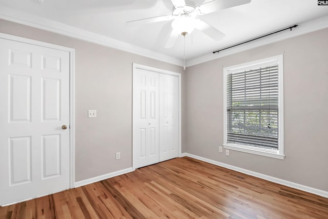 unfurnished bedroom with crown molding, baseboards, light wood-style flooring, and visible vents