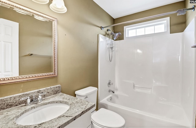 bathroom with vanity, toilet, and  shower combination