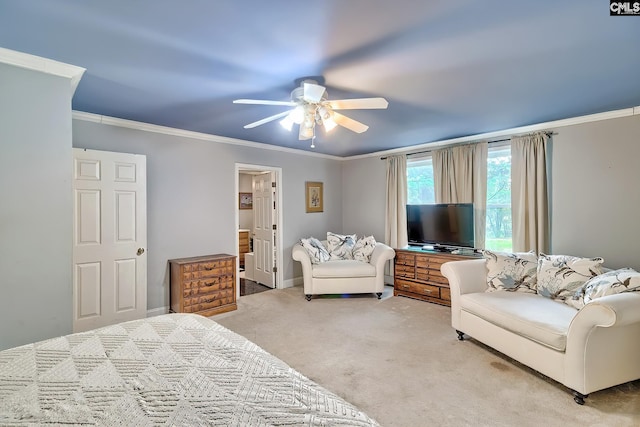 carpeted bedroom with crown molding, ensuite bathroom, and a ceiling fan
