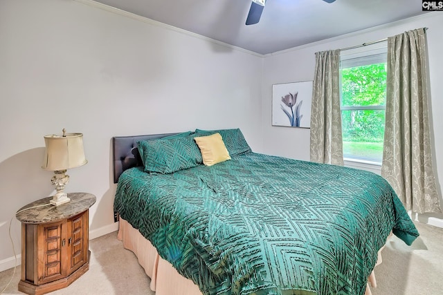 carpeted bedroom featuring crown molding, a ceiling fan, and baseboards